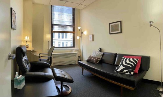 Greenwich Village Therapy Office With Large Window, Leather Couch, Desk, and Therapist Chair